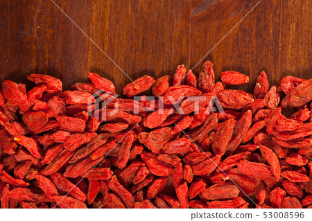 Goji berries on dark wooden surface Goji berries on dark wooden surface 53008596