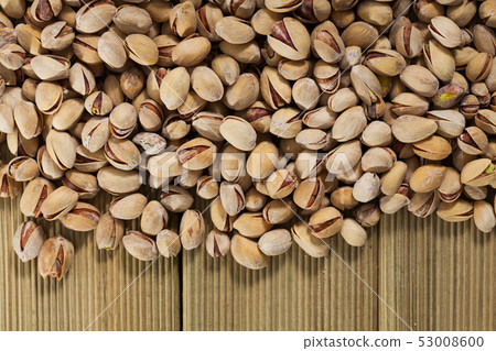 Pistachios on wooden surface Pistachios on wooden surface 53008600
