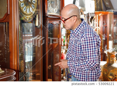 Portrait of mature man choosing vintage goods at antiques shop Portrait of mature man choosing vintage goods at antiques shop 53009221