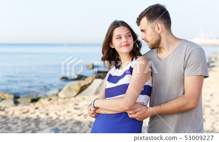 Happy loving couple standing and hugging Happy loving couple standing and hugging 53009227