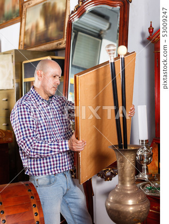 Portrait of mature man choosing vintage goods at antiques shop Portrait of mature man choosing vintage goods at antiques shop 53009247