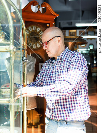 Portrait of mature man choosing vintage goods at antiques shop Portrait of mature man choosing vintage goods at antiques shop 53009321