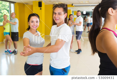 Three happy couples dancing tango 53009431