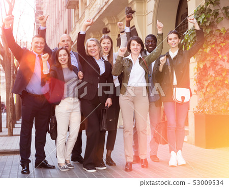 Men and women posing on street of city 53009534