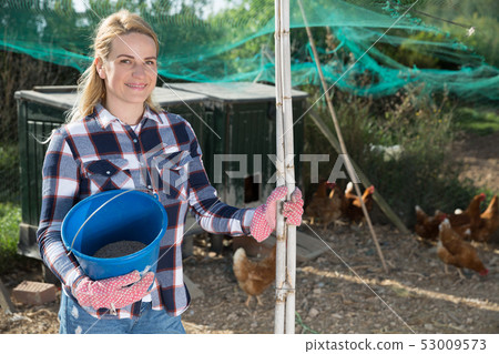 Female farmer on poultry yard 53009573