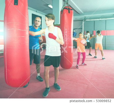 Young boxer earns blows on the punching bag 53009852
