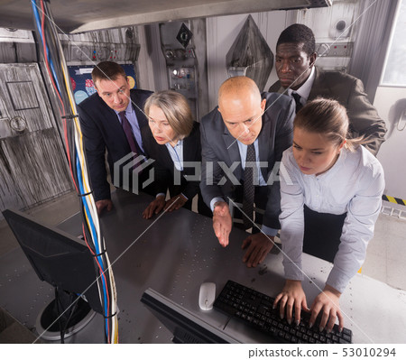 Businesspeople together near computer in quest room-lab Businesspeople together near computer in quest room-lab 53010294