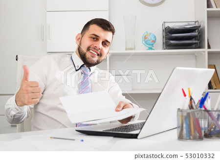 Man is signing agreement papers Man is signing agreement papers 53010332