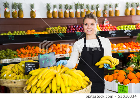 Salesgirl proposing bananas Salesgirl proposing bananas 53010334