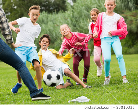 Cheerful children are jogning with ball Cheerful children are jogning with ball 53010335