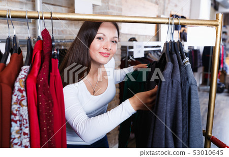 Positive cute girl customer buying fashion shirt 53010645