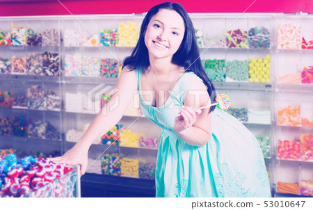Woman posing to photographer with lollypop 53010647