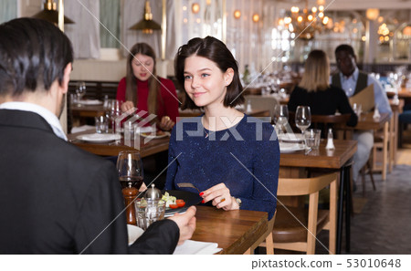 Woman with male colleague in restaurant Woman with male colleague in restaurant 53010648