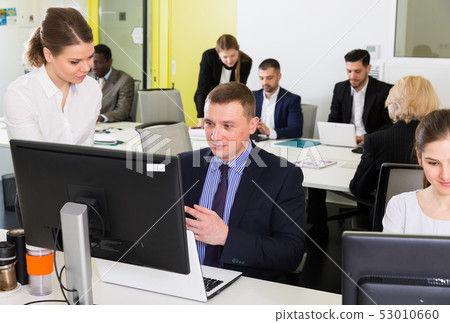 Business people working in open plan office 53010660
