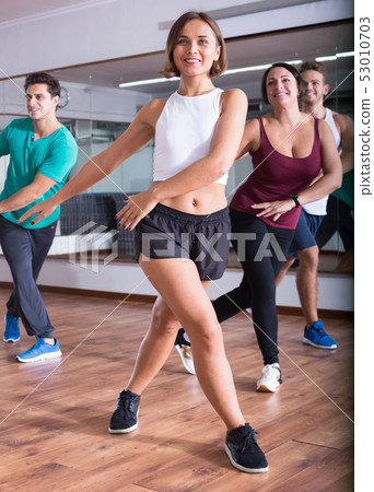 Young positive people dancing zumba elements 53010703