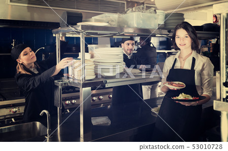 Portrait of adult waiter standing with order Portrait of adult waiter standing with order 53010728