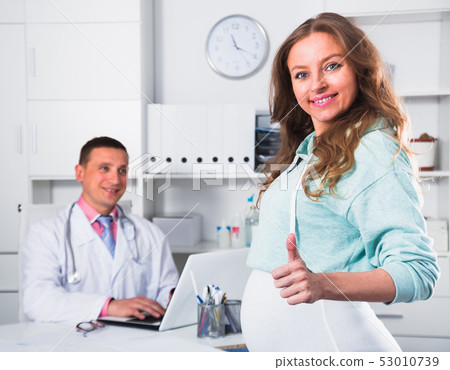 Doctor and pregnant visitor Doctor and pregnant visitor 53010739