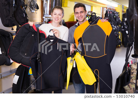 woman and man with diving equipment 53010740