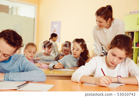Teacher and pupils working in classroom Teacher and pupils working in classroom 53010742