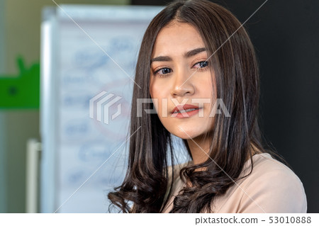 Portrait of asian young businesswoman in formal suit standing in the workplace Portrait of asian young businesswoman in formal suit standing in the workplace 53010888
