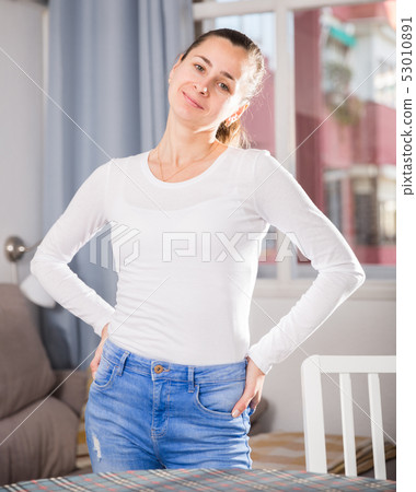 Young slim woman standing at home 53010891