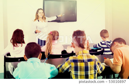 Little children with teacher in classroom 53010897