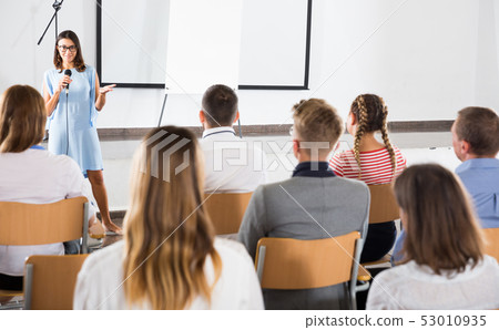 Female coach giving presentation for audience Female coach giving presentation for audience 53010935