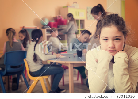 Portrait of sad brunette girl and children 53011030