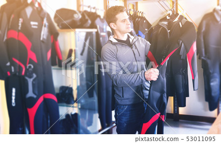 Male is standing with costume for diving Male is standing with costume for diving 53011095