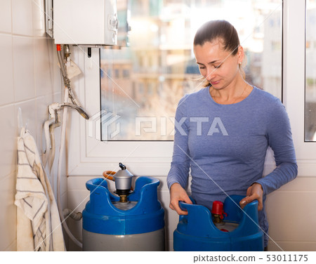 Housewife connecting boiler to gas cylinder Housewife connecting boiler to gas cylinder 53011175
