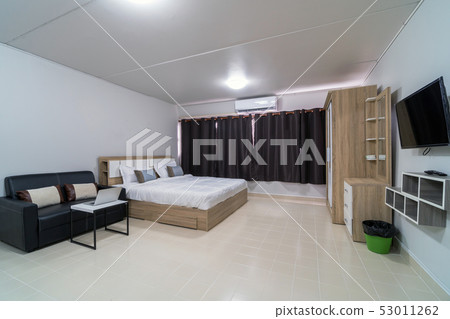 Luxury Interior bedroom with leather sofa of living room, Studio room type of condominium or apartment, service apartment and Accommodations Concept 53011262