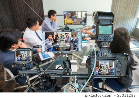 Professional set of camera with smart mobile phone and action camera on tripod over Group of asian Business team having video conference with their manager, Live Streaming for entrepreneur concept Professional set of camera with smart mobile phone and action camera on tripod over Group of asian Business team having video conference with their manager, Live Streaming for entrepreneur concept 53011282