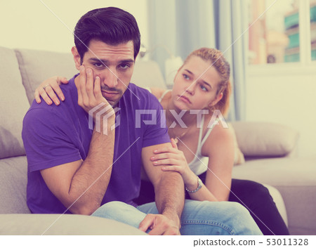 Woman calming distressed husband Woman calming distressed husband 53011328