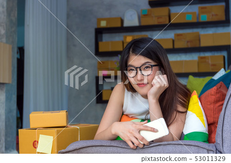 Young asian teenager owner business woman work at home for online shopping, checking order and prepaing package the product with office equipment, entrepreneur and alpha generation life style concept Young asian teenager owner business woman work at home for online shopping, checking order and prepaing package the product with office equipment, entrepreneur and alpha generation life style concept 53011329