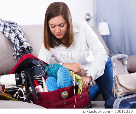Woman packing for holiday Woman packing for holiday 53011330
