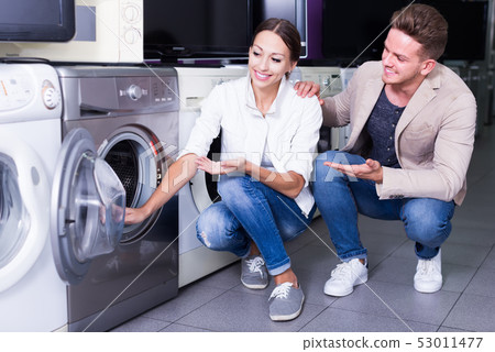 Happy family couple buying new clothes washer 53011477