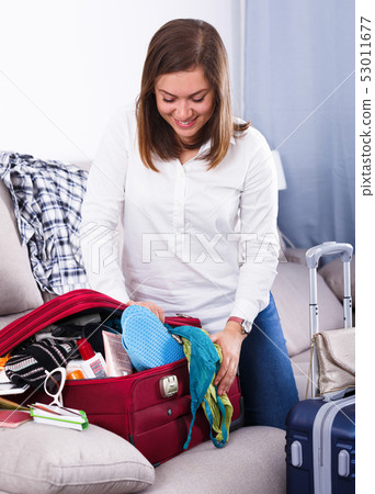 Woman packing for holiday Woman packing for holiday 53011677