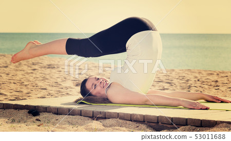 Woman doing yoga sitting Woman doing yoga sitting 53011688