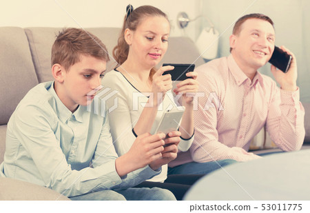 Parents and son using phones Parents and son using phones 53011775