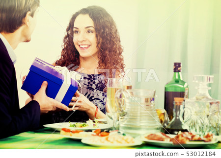 Man giving present to woman 53012184