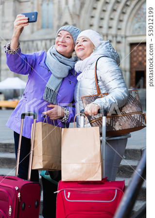 Elderly women tourists making selfie with phone Elderly women tourists making selfie with phone 53012199