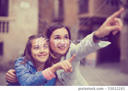 Adult mother pointing to daughter new sight Adult mother pointing to daughter new sight 53012281