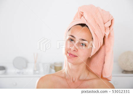Adult woman with a towel on her head 53012331