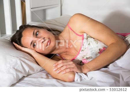 Cute adult woman in pygamas sleeping in bed in bedroom Cute adult woman in pygamas sleeping in bed in bedroom 53012612