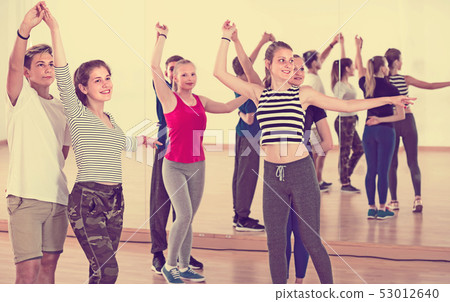 smiling teens studying folk style dance 53012640