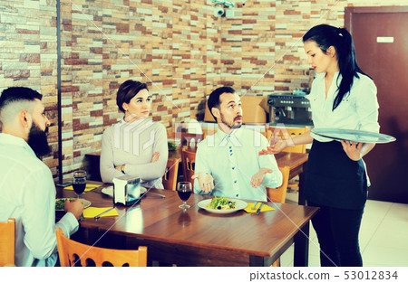 Unpleased client talking with manager in restaurant 53012834