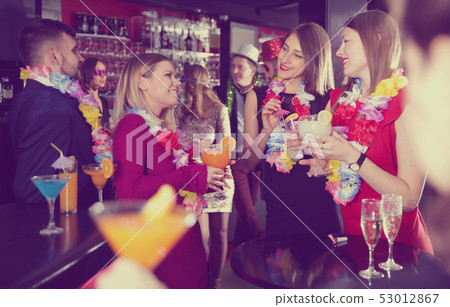 Colleagues on corporate Hawaiian party in bar Colleagues on corporate Hawaiian party in bar 53012867