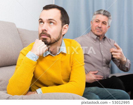 Adult father and son solve problems Adult father and son solve problems 53012995