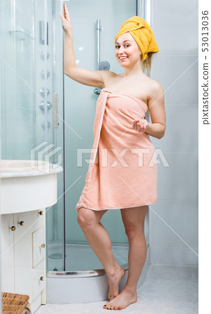 woman partly cover with bath towel woman partly cover with bath towel 53013036