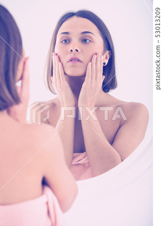 Woman using mirror 53013209